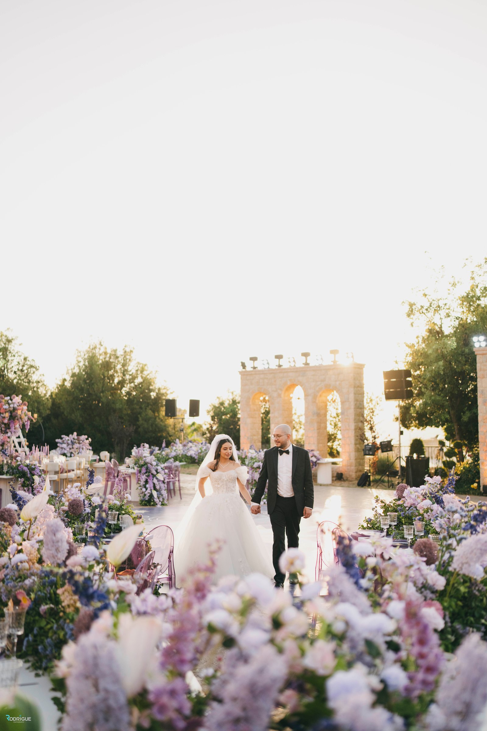 Blush-toned candlelit garden staircase leading to the reception
